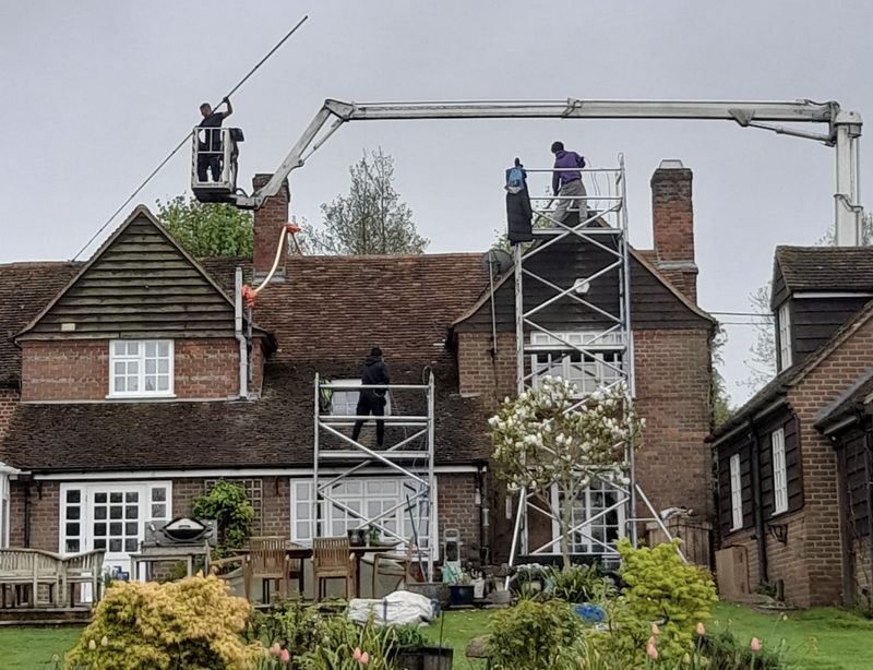 The Moss Cleaners using cherry picker and scaffolding to clean roof safely and professionally in Bishop's Waltham, Hampshire
